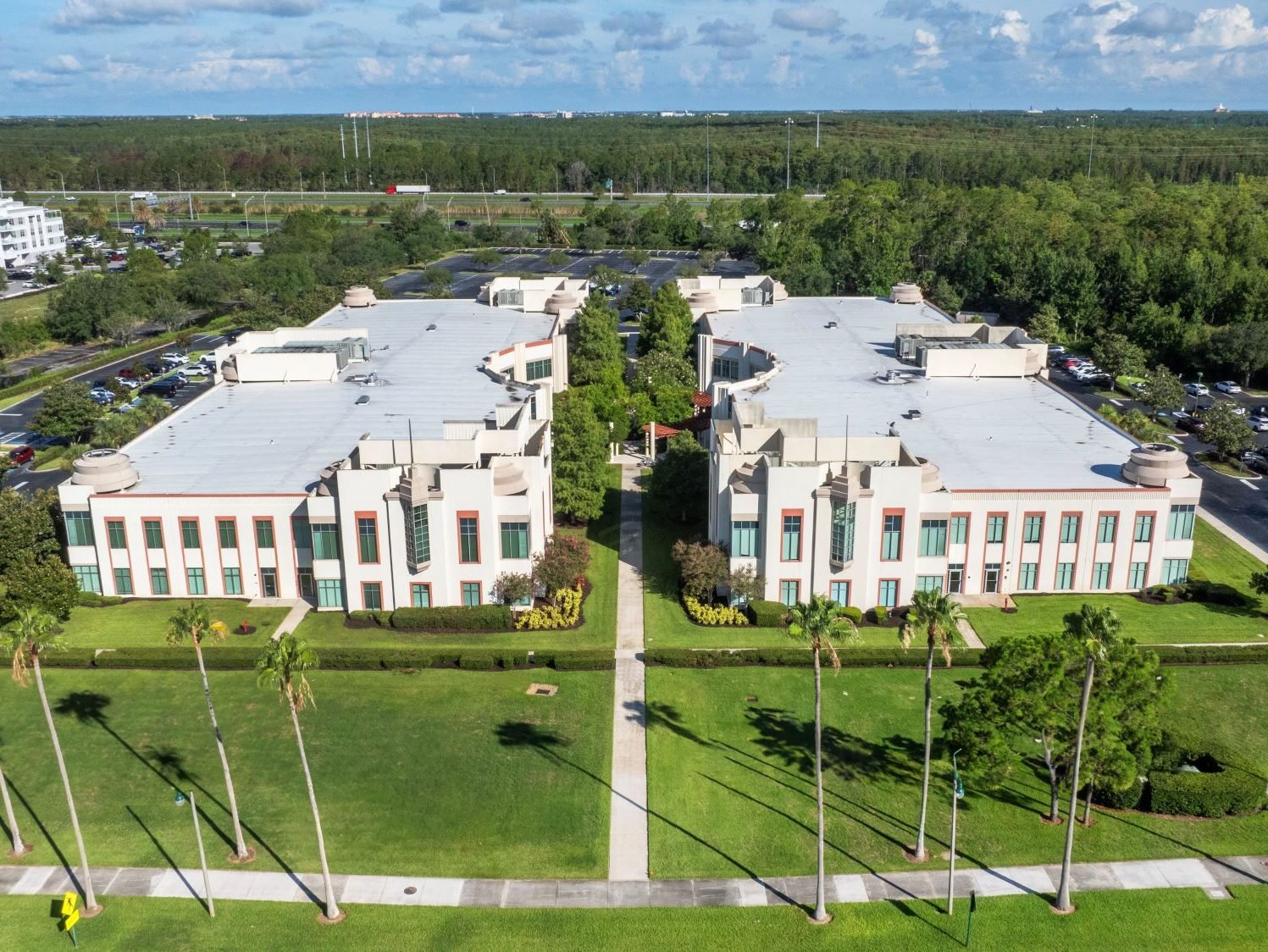 Aerial shot of Celebration Office Center, a 161,437-square-foot property in Kissimmee, Fla. consisting of two two-story buildings across 12 acres.