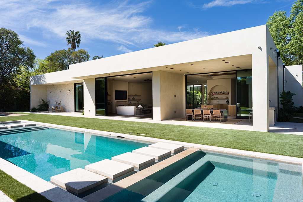 Rear exterior of the home with swimming pool in the foreground