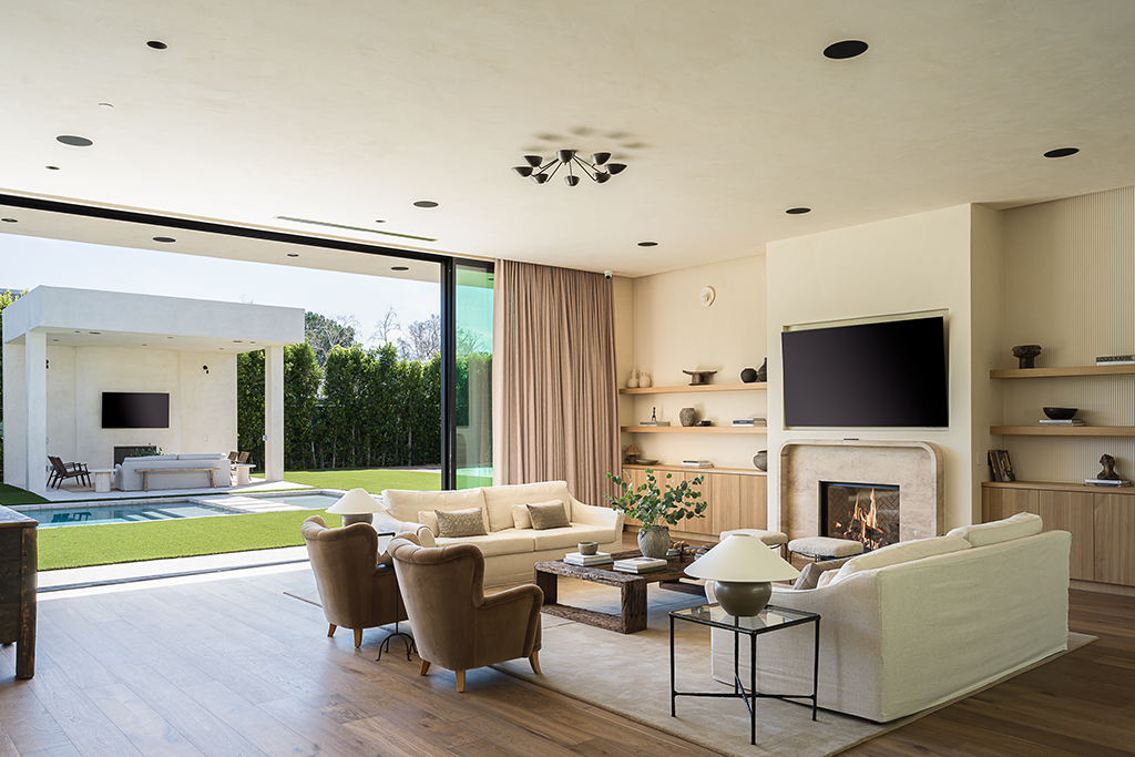 Living Room with fireplace with retracting glass doors that open to the backyard