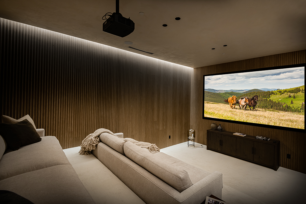Theater room with tiered seating and fluted accent walls