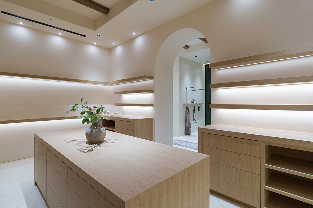 Walk-in closets with light oak, ultra-modern built in cabinetry and shelving