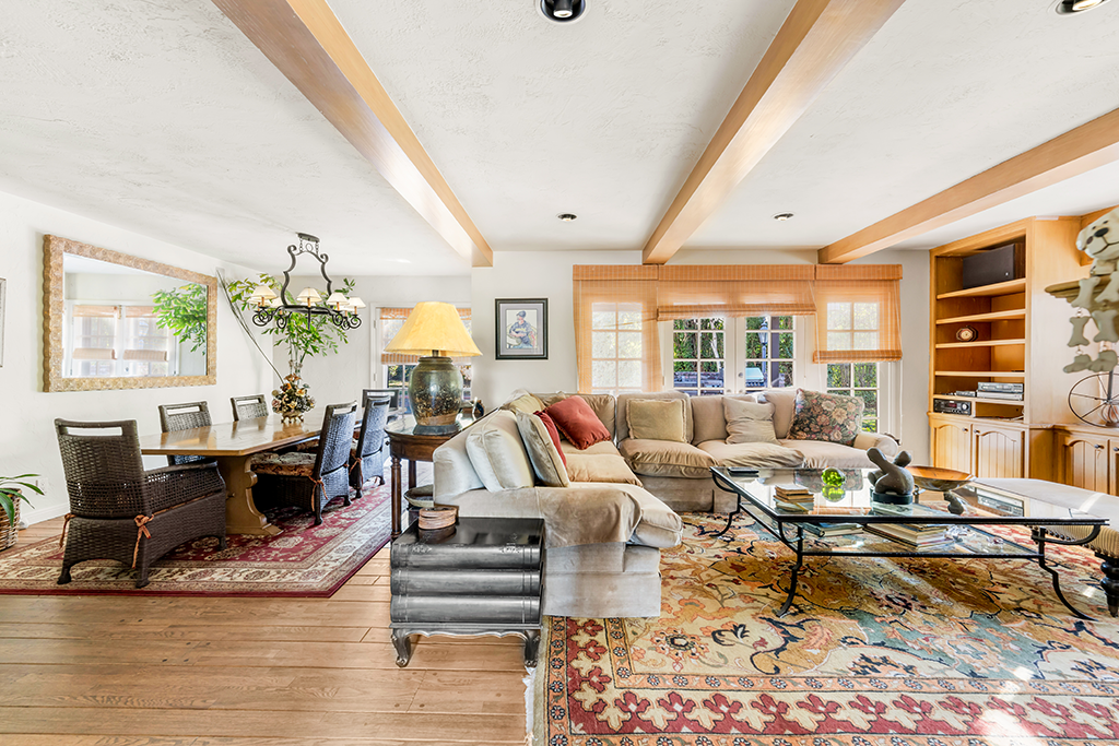 Living Area in Main House | The Agency Journal Living and dining room with fireplace and built-in cabinets