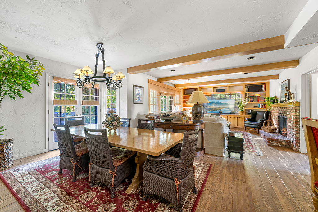 Dining Room and Living Room | The Agency Journal Dining room and living room with fireplace and beamed ceilings