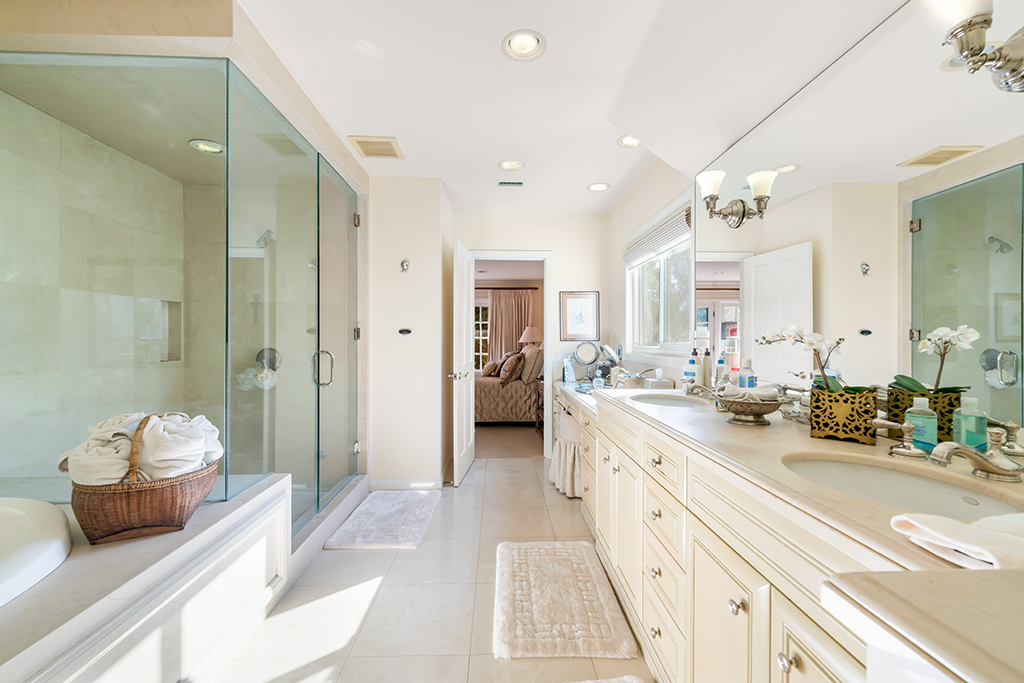 Primary Ensuite Bathroom | The Agency Journal Master bathroom with double sinks, soaker tub and glass-walled shower