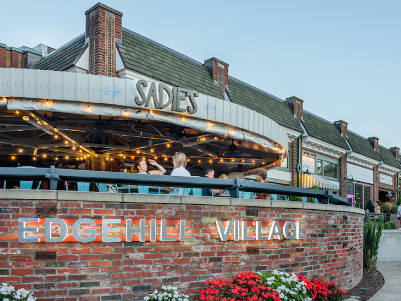 Exterior view of restaurant with guests sitting in an outside