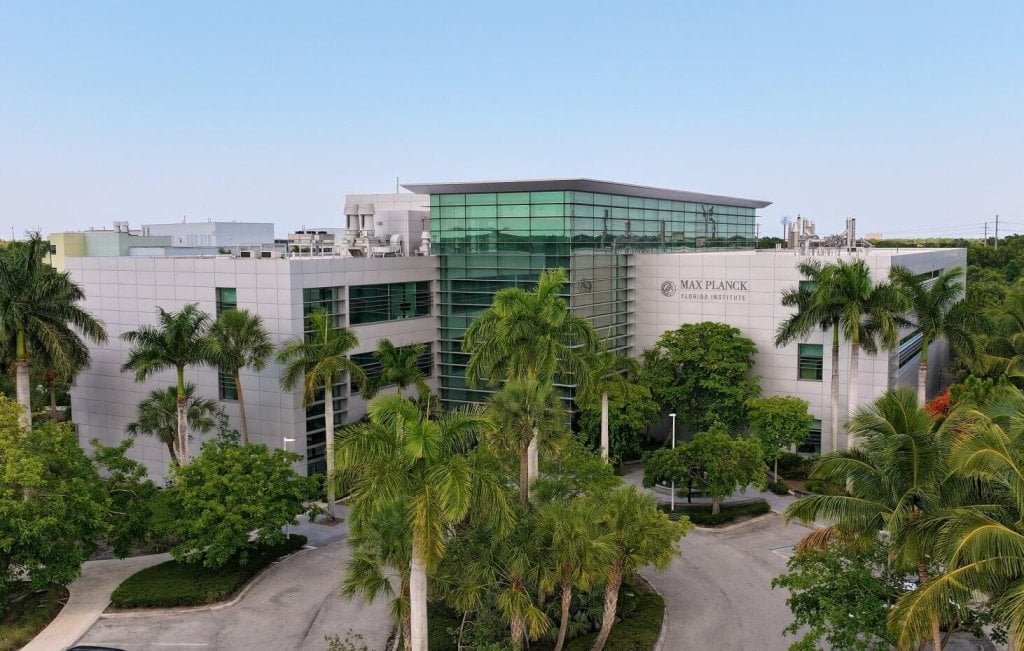 A building surrounded by palm trees, representing the life sciences and tech ecosystem in Palm Beach County.