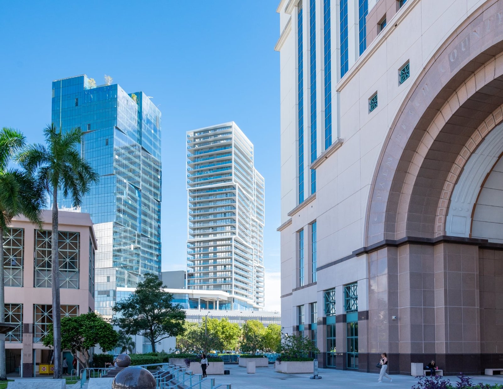 A significant structure with a large archway, illustrating Palm Beach County's role as a hub for innovation and development.