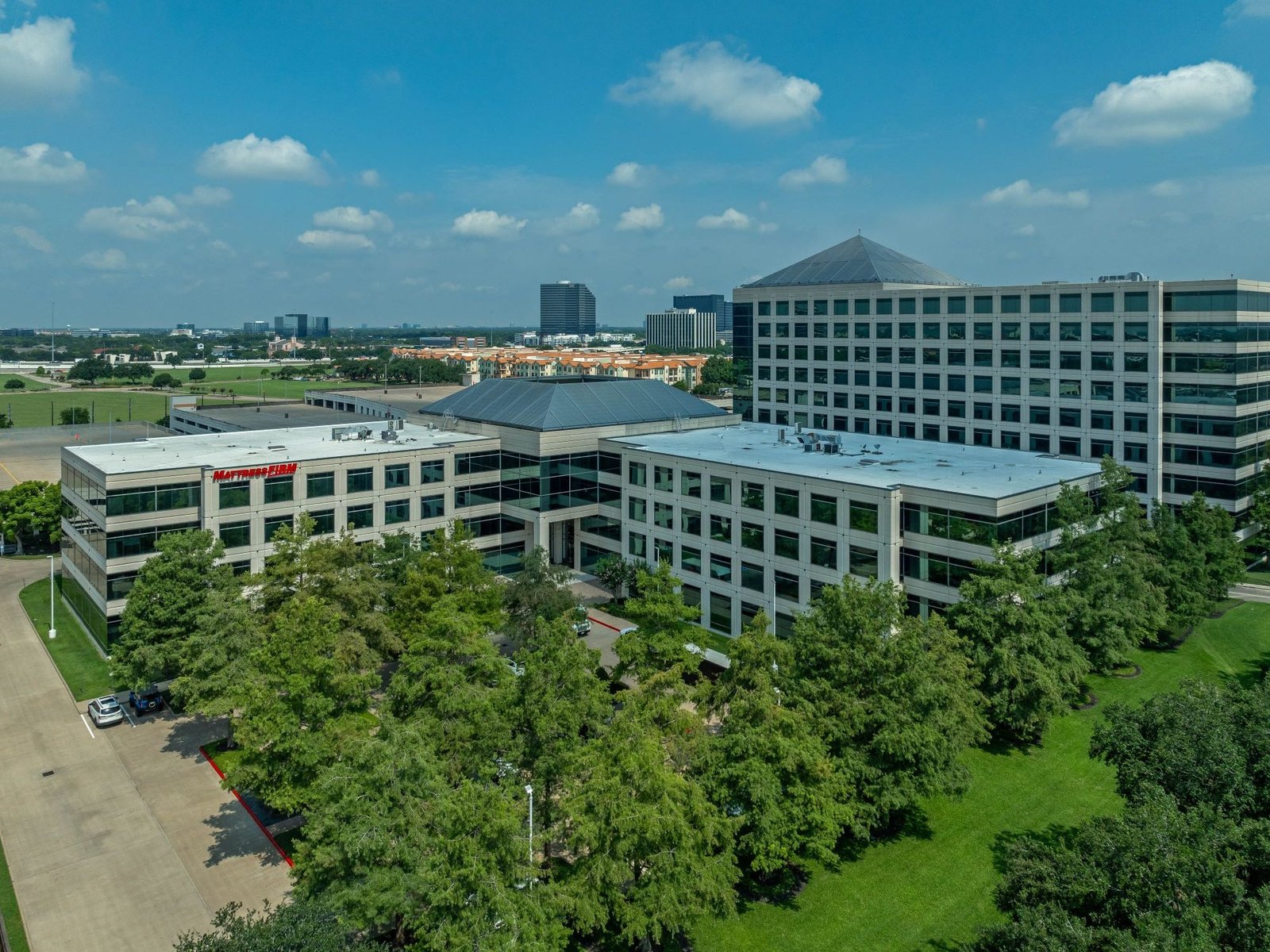 Exterior shot of the four-story office building Reserve at Westchase in Houston