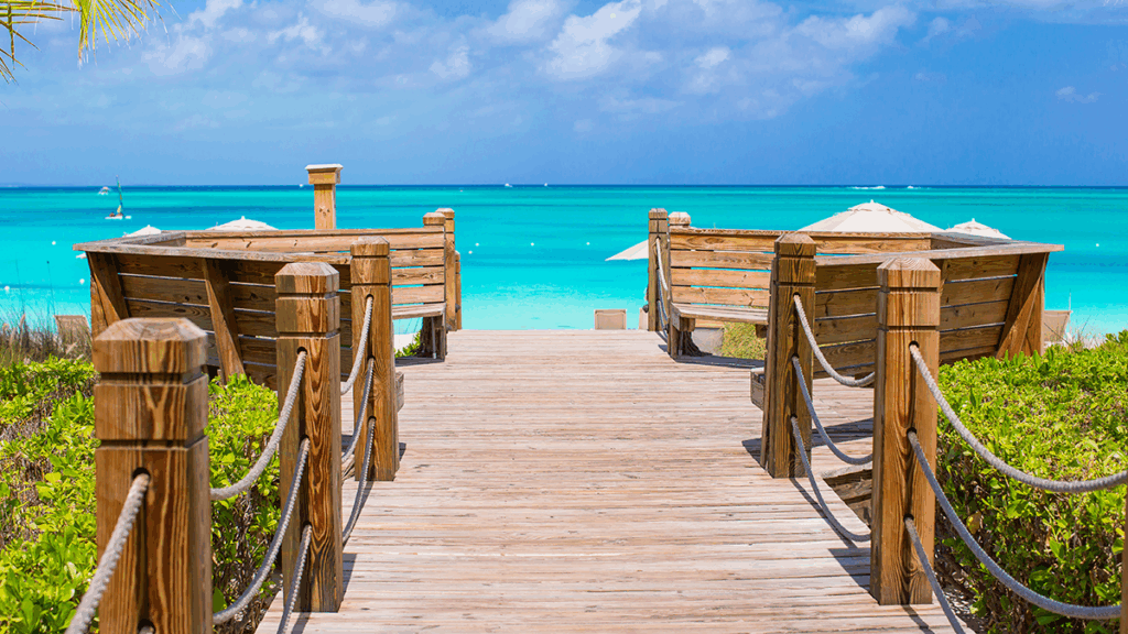 Wooden pathway leading to Caribbean beach and turqoise waters
