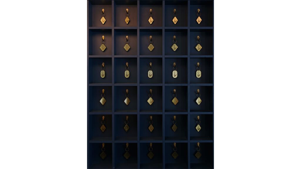 Display case with gold-toned hotel room keys for the Municipal Grand Hotel in Savannah, Georgia.