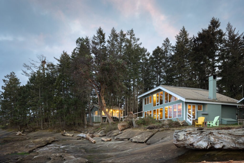 A house surrounded by forest and rocky terrain