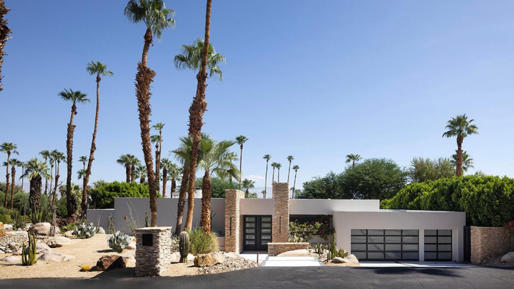 Contemporary single-family home in Rancho Mirage with mountain views, palm trees, and pool.