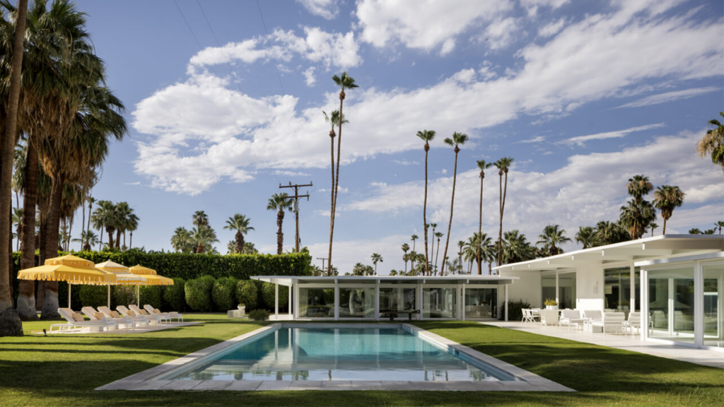 Contemporary single-family home in Rancho Mirage with mountain views, palm trees, and pool.