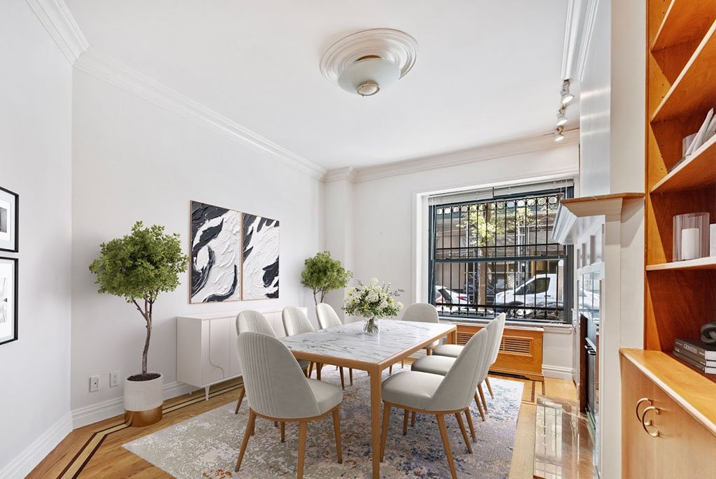 Modern dining room at 259 West 90th Street featuring a marble table with white chairs, abstract black-and-white art, and large windows.