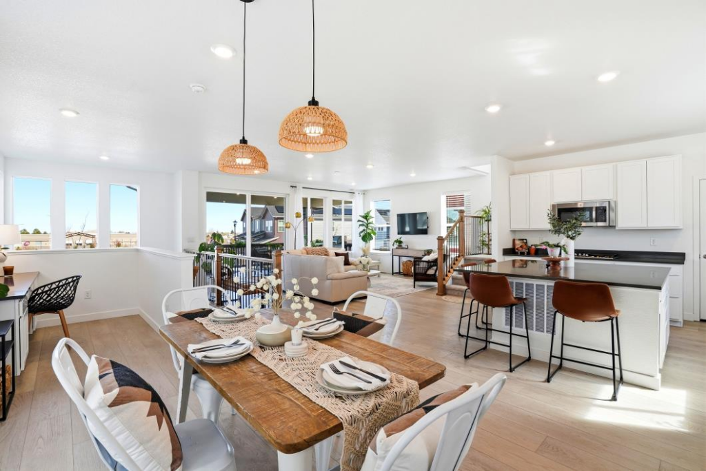 Open concept interior at 2334 Carioca Pl, Vista, CA with a modern white kitchen, dining area, and woven pendant lights.
