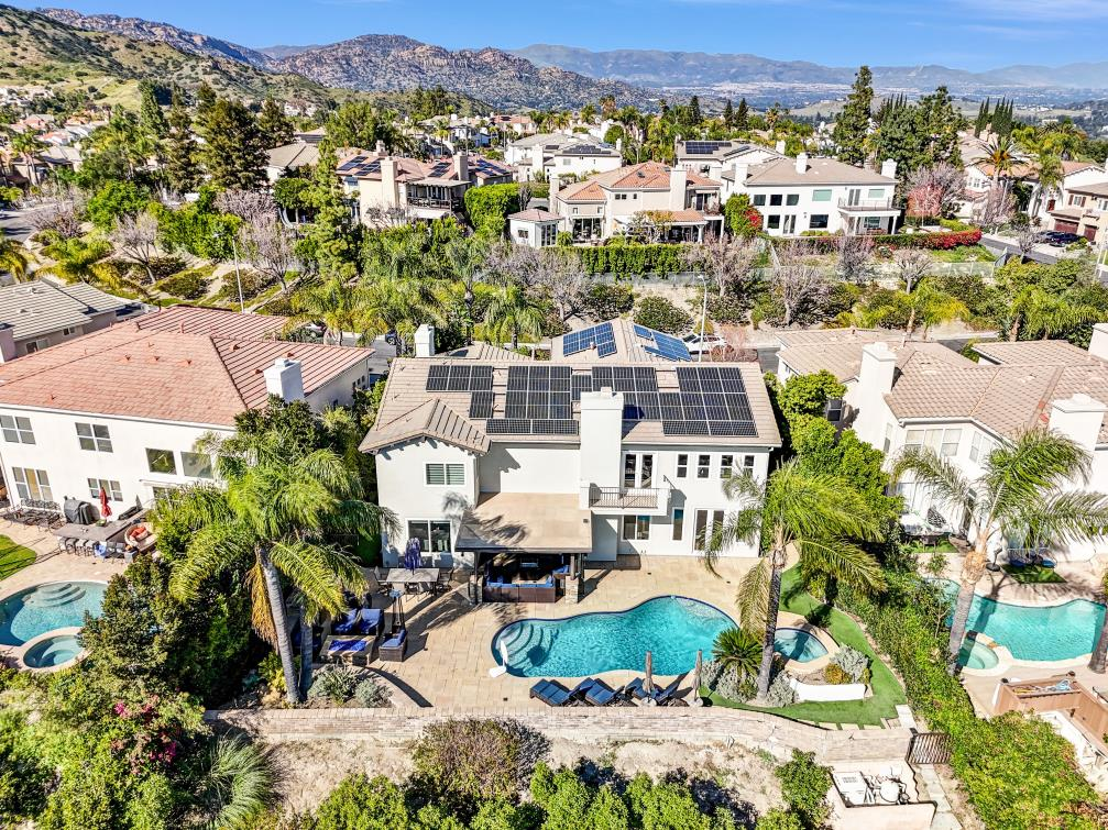 Aerial view of a luxury Mediterranean home at 2339 Carioca Pl, Vista, CA with a resort-style pool and solar panels