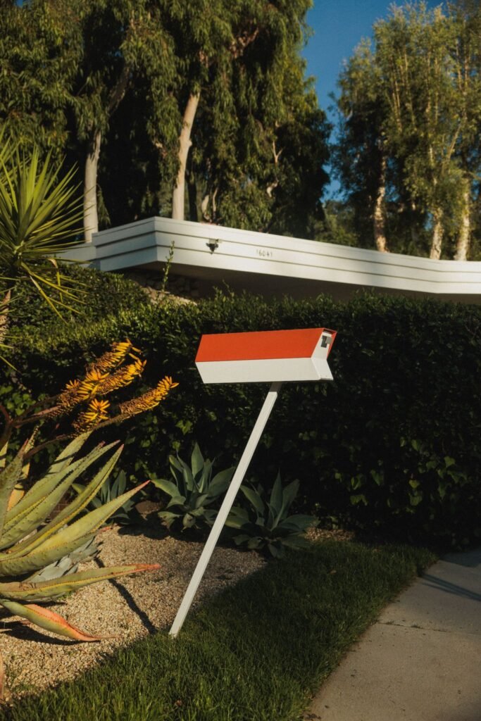 Mid-century modern mailbox and desert landscaping at a luxury residential property.