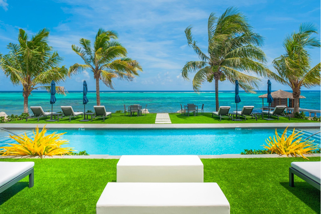 Private beachfront swimming pool and oceanfront lounge deck at Black Urchin Boutique Resort in Grand Cayman.