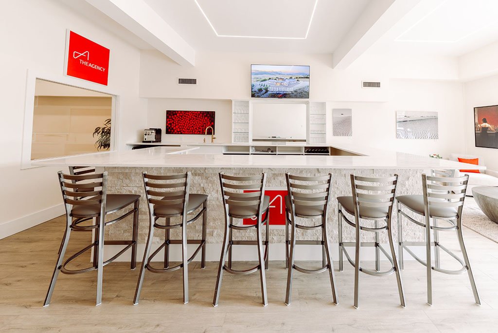Modern community event space and reception bar at The Agency real estate headquarters in Fairfield Connecticut