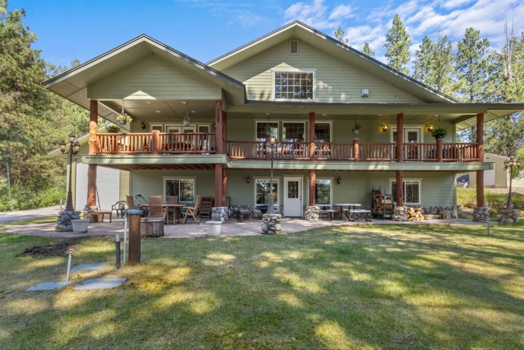 Two-story mountain home facade with expansive covered decks at 14 White Mesa in Banks Idaho.