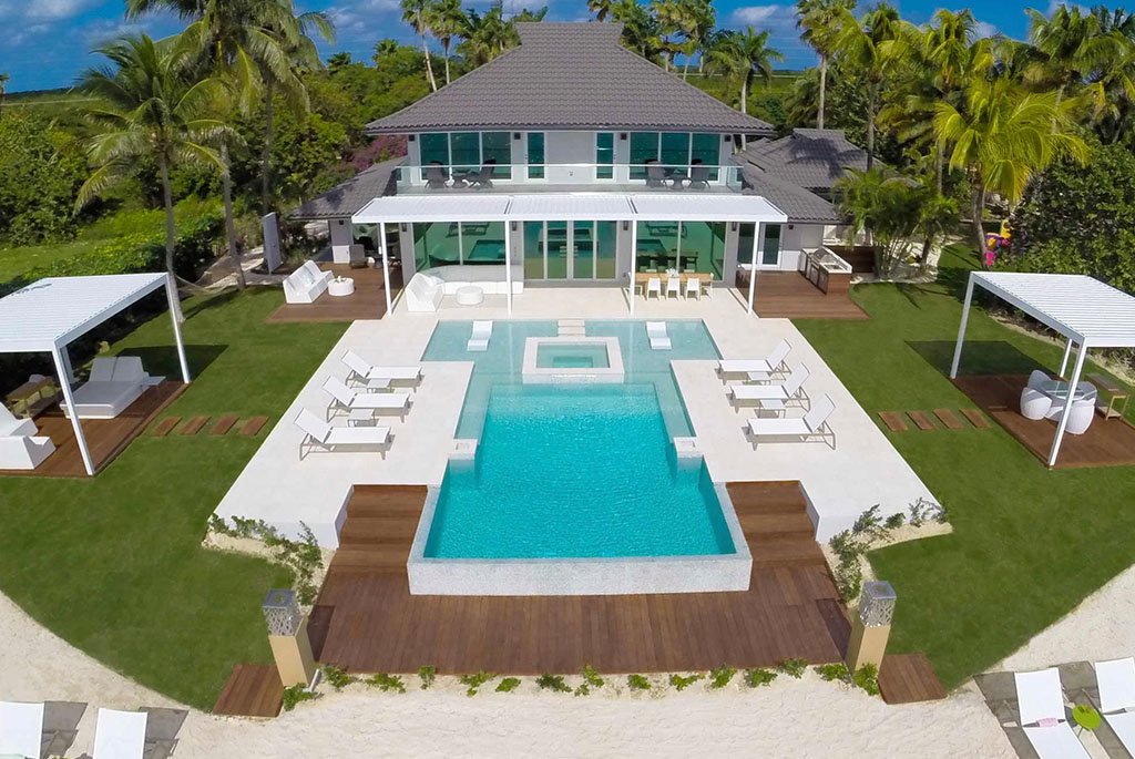 Aerial view of the beachfront luxury estate and swimming pool deck at Black Urchin Private Beachfront Estate in Grand Cayman.