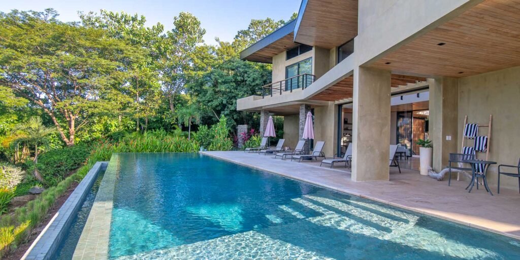Modern luxury villa facade and infinity pool at Dos Monitos Luxury Compound in Playa Grande Costa Rica.