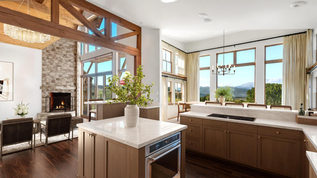 Open gourmet kitchen and stone fireplace living room at Paradise Ridge in Carbondale Colorado.