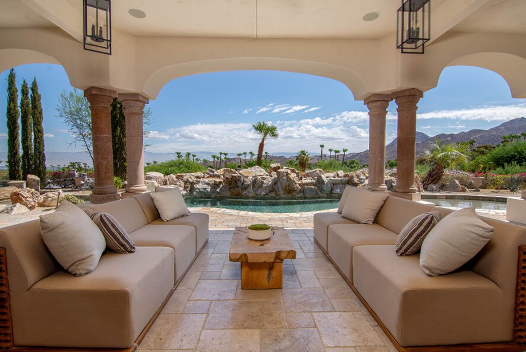 Covered outdoor patio with stone pillars and pool view at 49769 Desert Vista Drive in Palm Desert California.