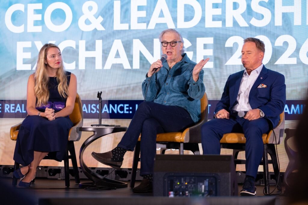 Laura Corrigan of The Agency sits with real estate panelists speaking on stage at RISMedia's 2026 CEO and Leadership Exchange.