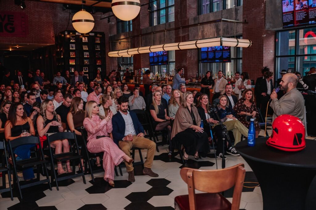 An audience listening to the "Building What’s Next" real estate and business panel presentation inside the Big Night Live music hall in Boston.