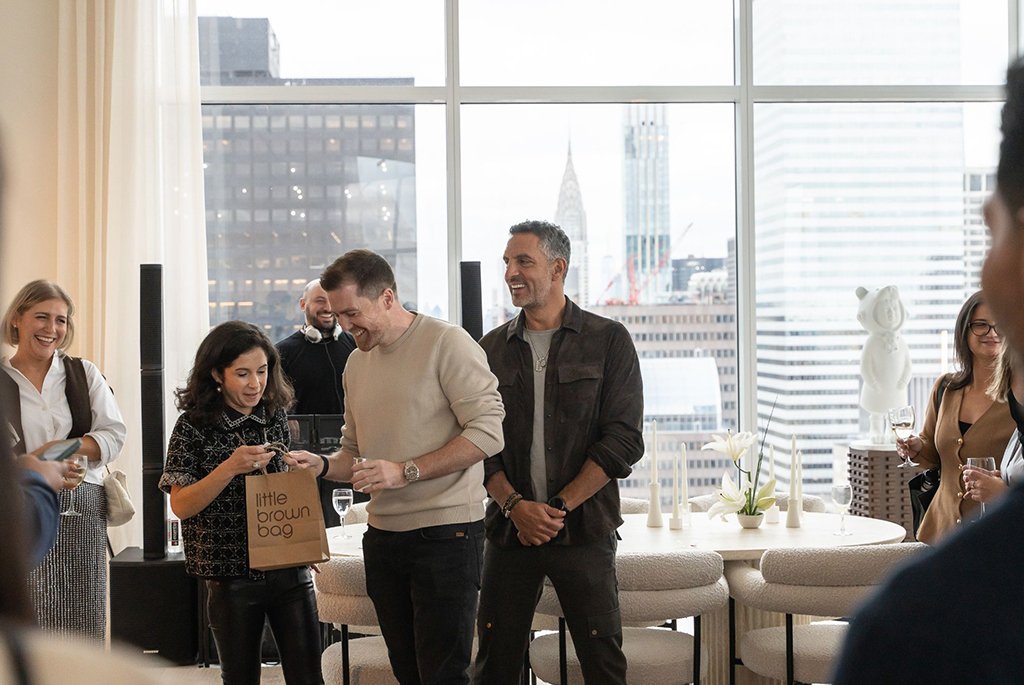 The Agency CEO Mauricio Umansky and rennie President Greg Zayadi presenting a Bloomingdale's raffle prize at The Elysia launch event in Midtown Manhattan.