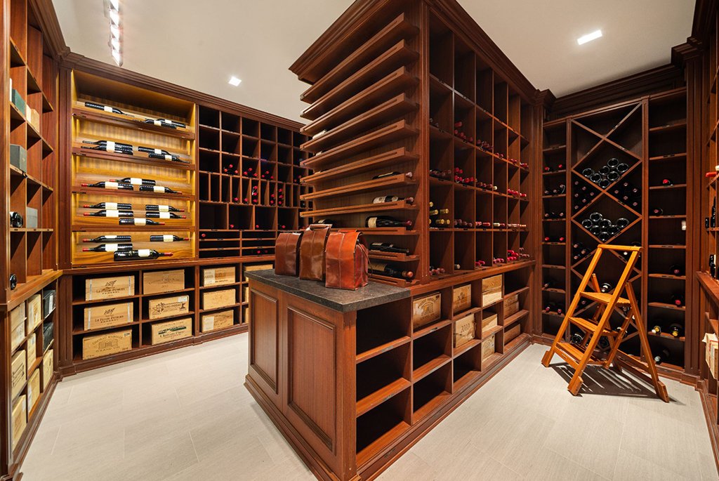 Temperature-controlled 6,319-bottle wine cellar with custom wood racks on the lower level at 165 East 70th Street townhouse.